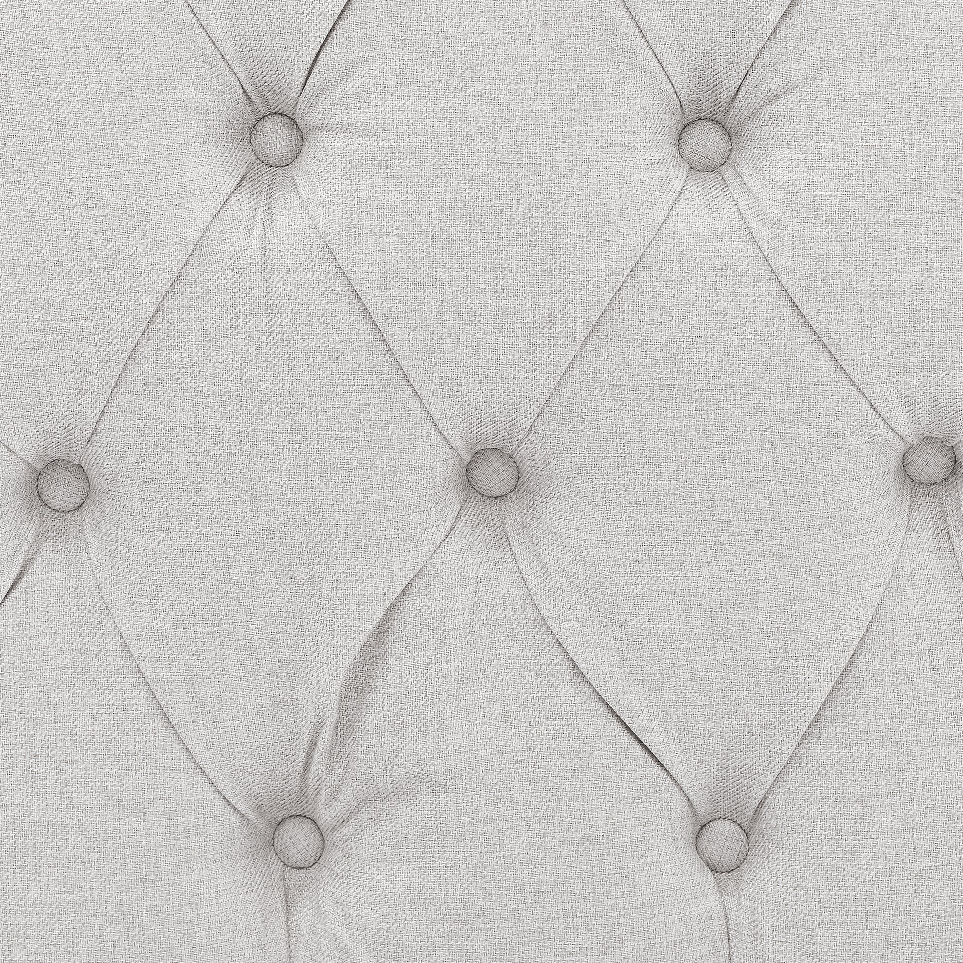 Closeup of light grey linen fabric with diamond tufting perfect for upholstery