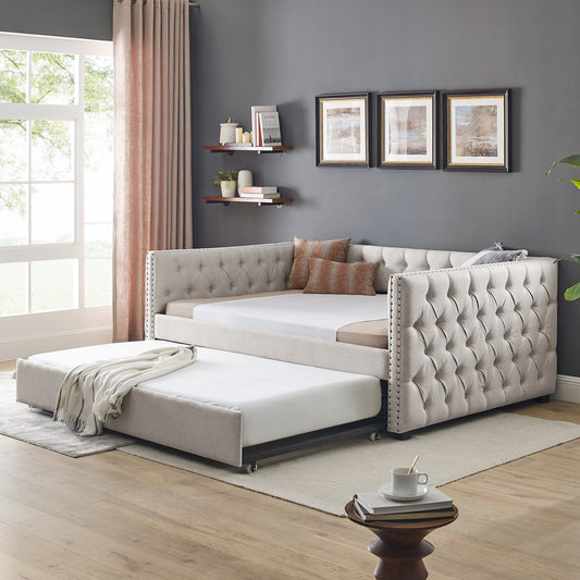 Tufted beige fabric daybed with pullout trundle for guest sleeping