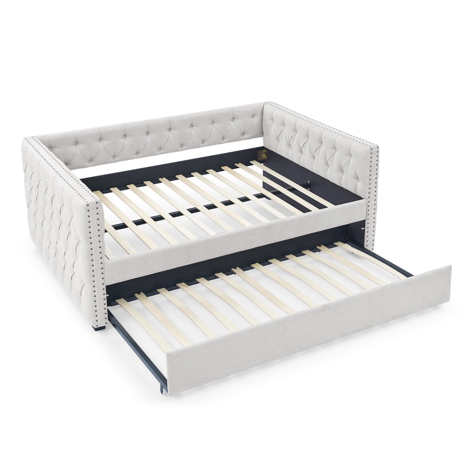 Tufted light gray fabric daybed with pullout trundle and silver nailhead trim