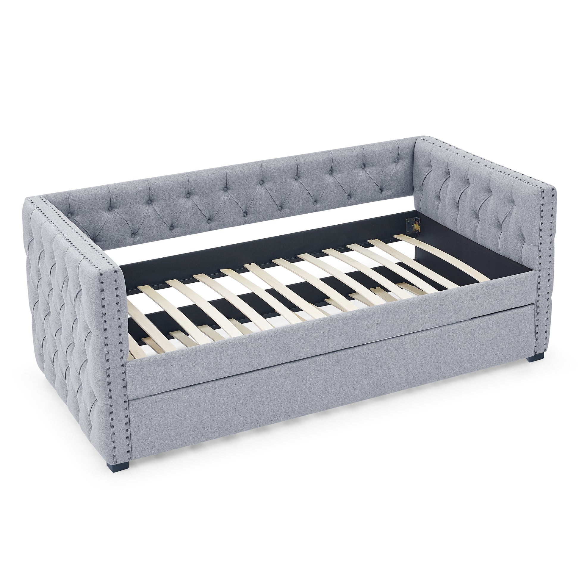 Grey upholstered daybed with tufted back and nailhead trim