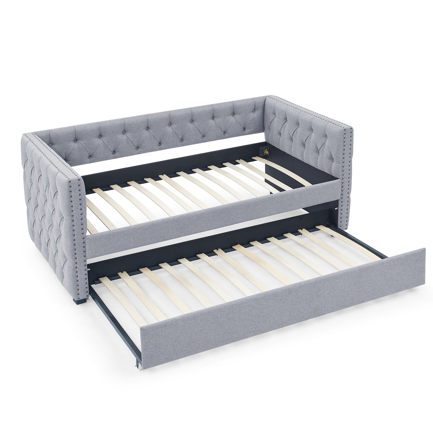 Tufted grey fabric daybed with pullout trundle featuring studded trim for a classic look