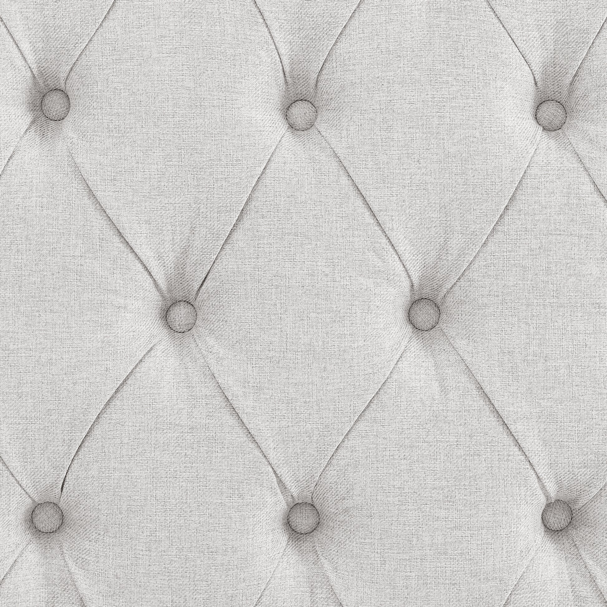 Closeup of a light gray textured fabric with diamond tufting and buttons ideal for upholstery
