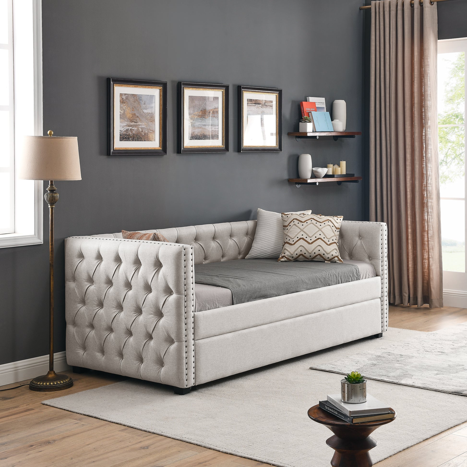 Elegant beige tufted daybed with studded trim perfect for living room seating