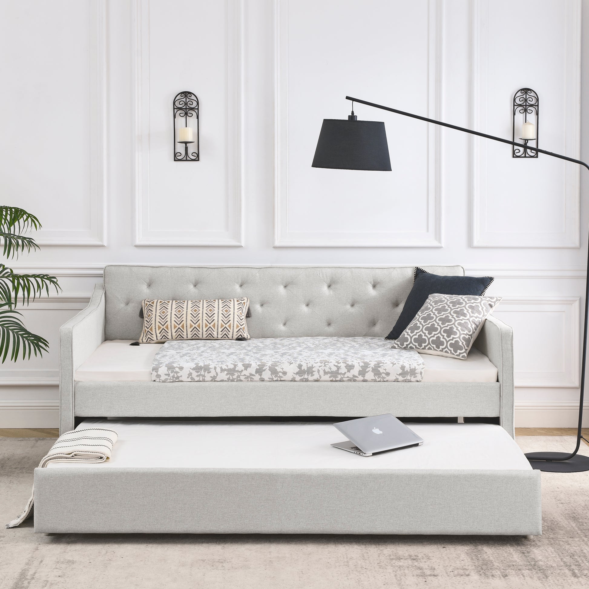 Light gray fabric daybed with pullout trundle and tufted backrest