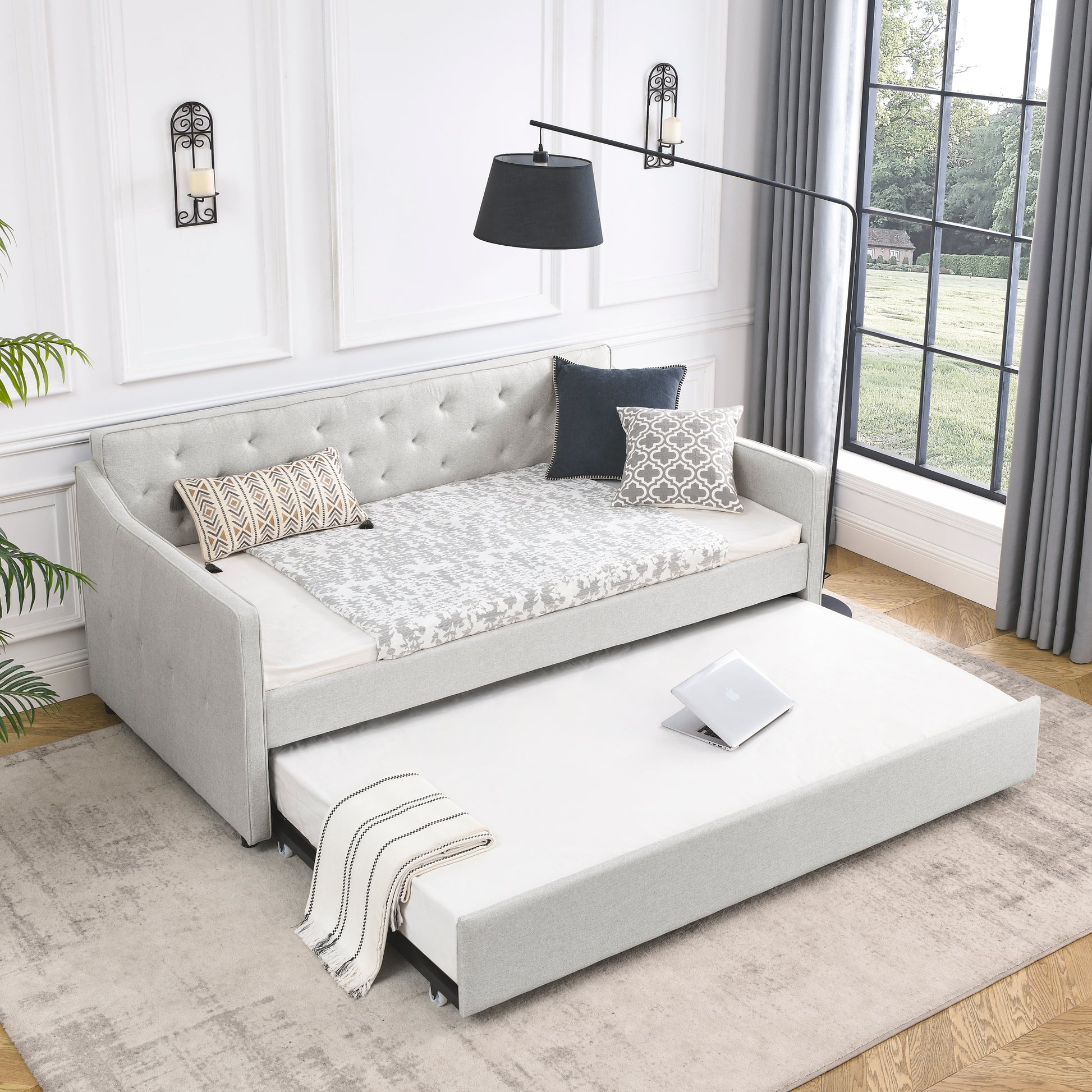 Light gray upholstered daybed with pullout trundle perfect for guest rooms