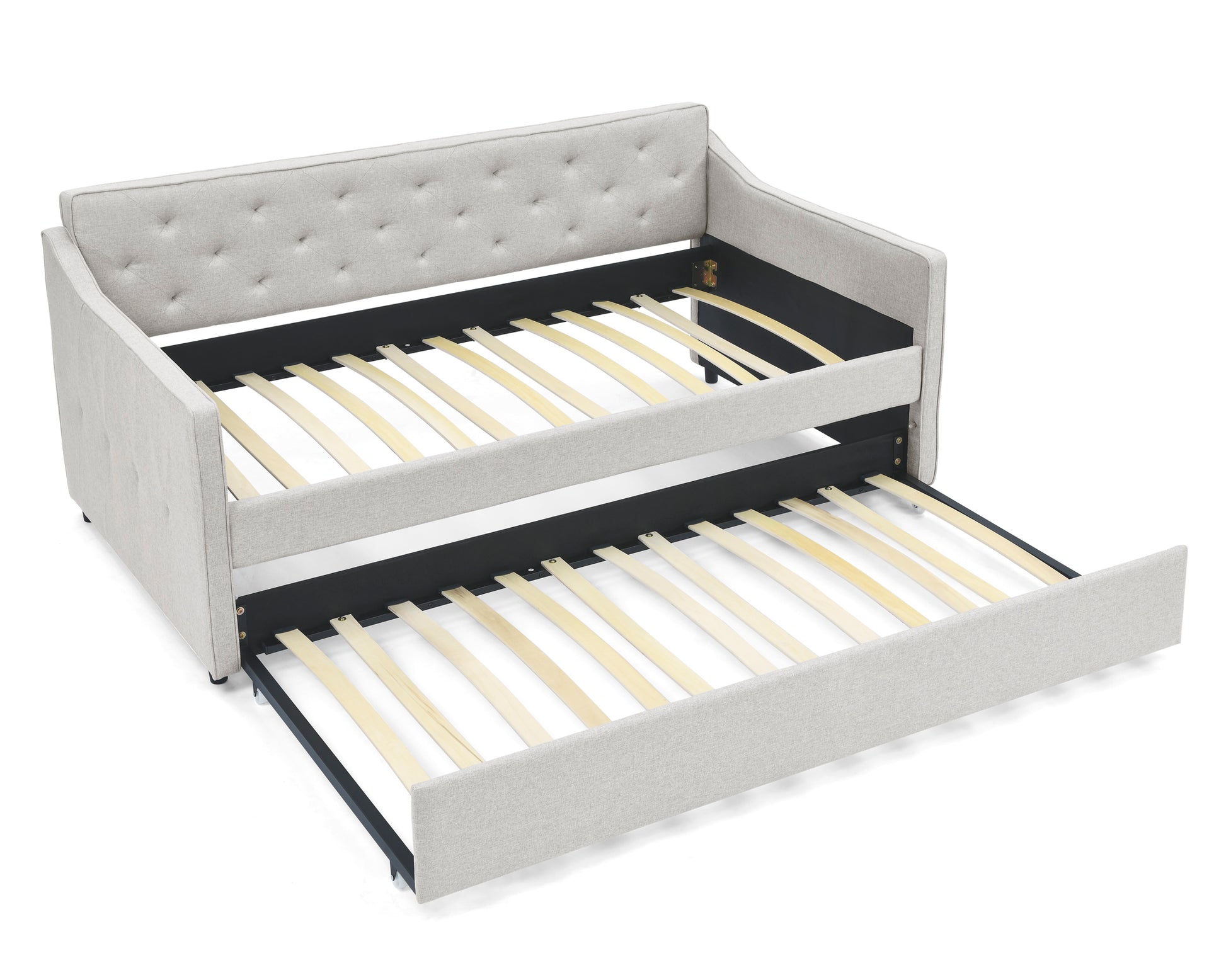 Light grey upholstered daybed with a pullout trundle bed featuring tufted backrest and wooden slats