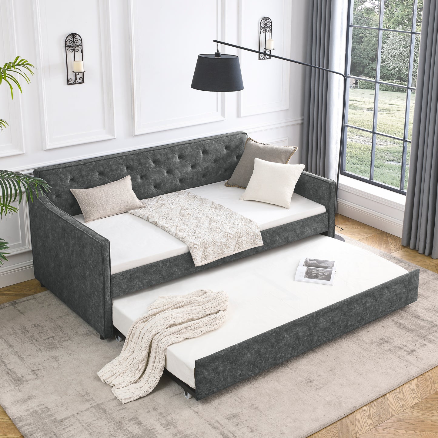 Tufted dark grey fabric daybed with pullout trundle perfect for guest rooms