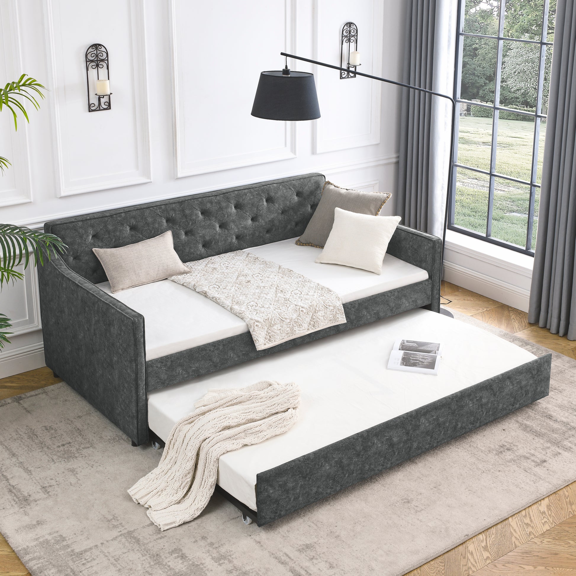 Tufted dark grey fabric daybed with pullout trundle perfect for guest rooms
