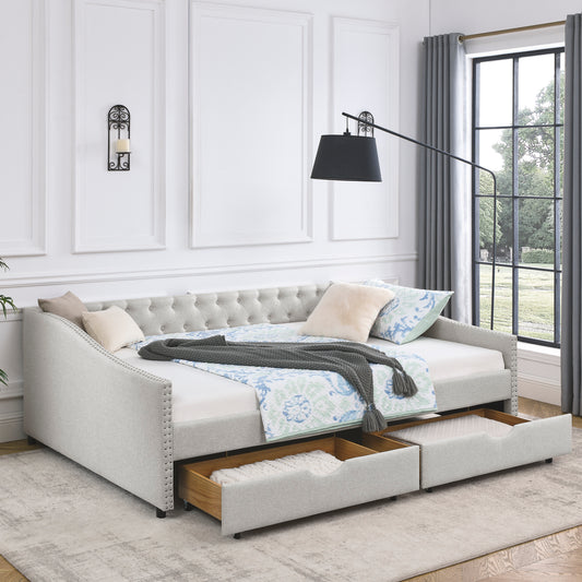 Tufted back light gray fabric daybed with two storage drawers and decorative nailhead trim