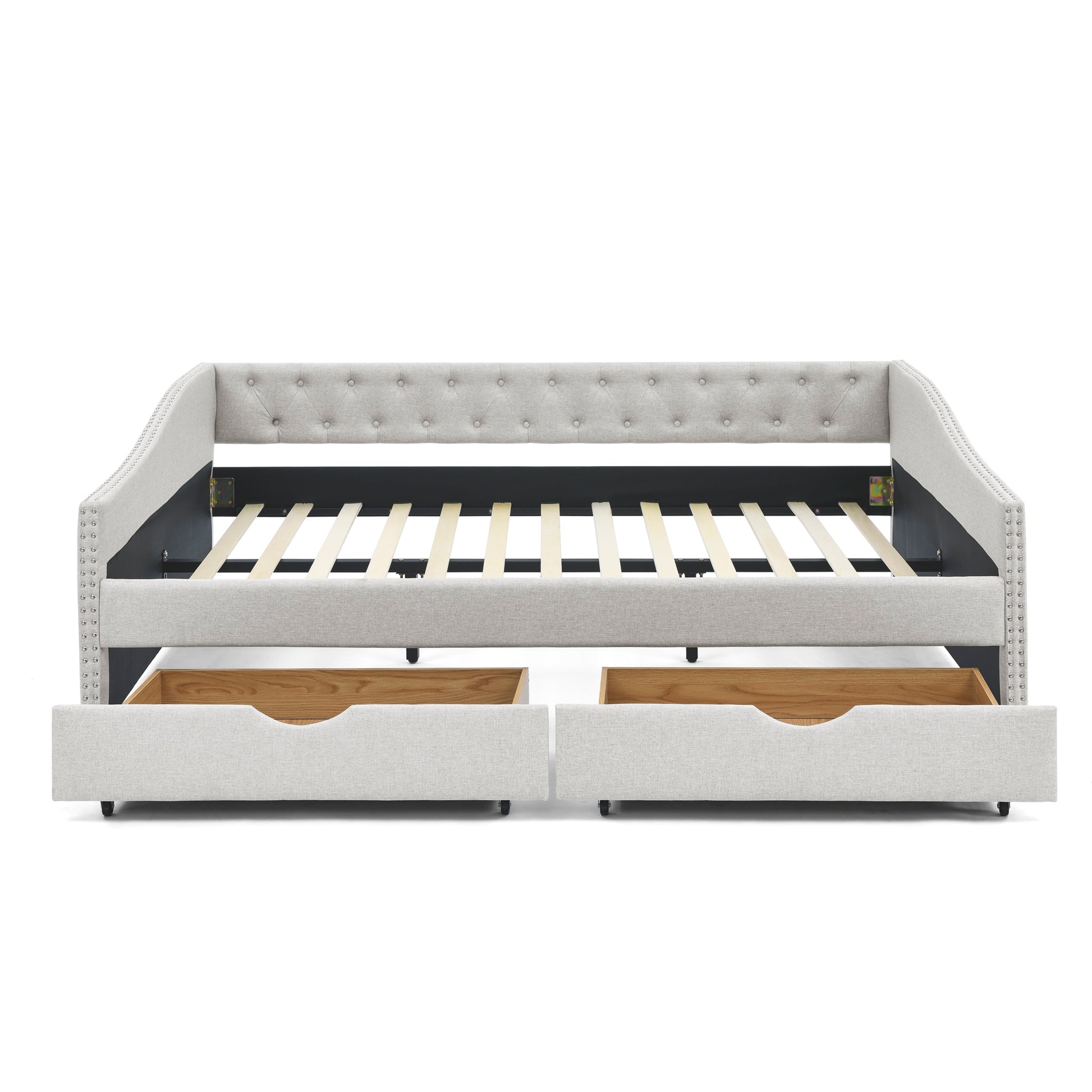 Light gray upholstered daybed with button tufting and nailhead trim featuring two pullout drawers