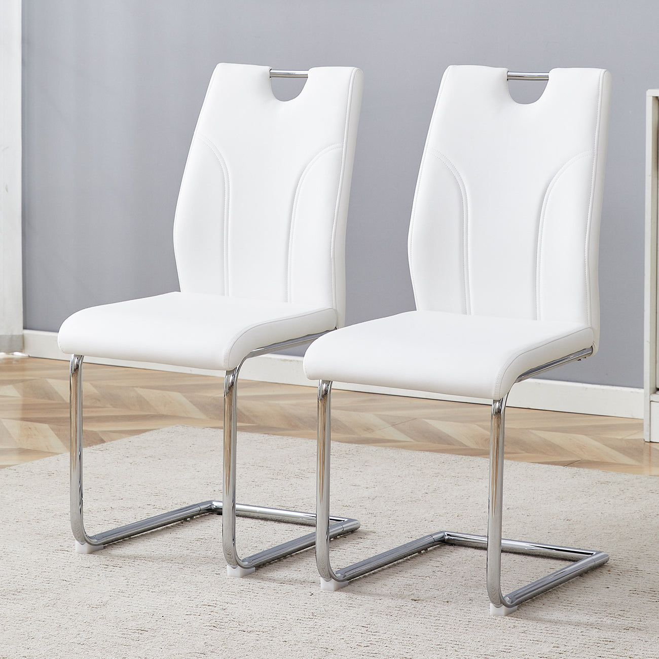 White faux leather dining chairs with chrome sled base