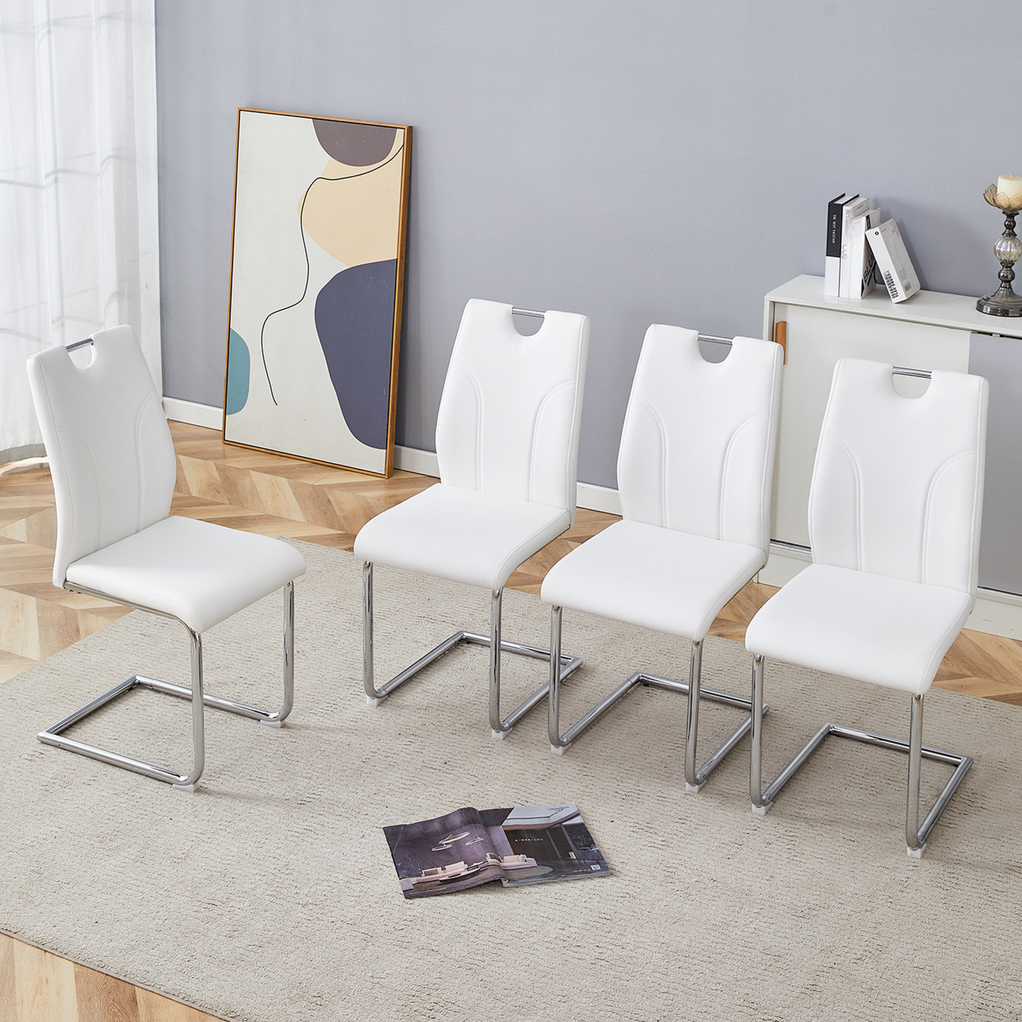 Set of four white faux leather cantilever dining chairs with chrome legs