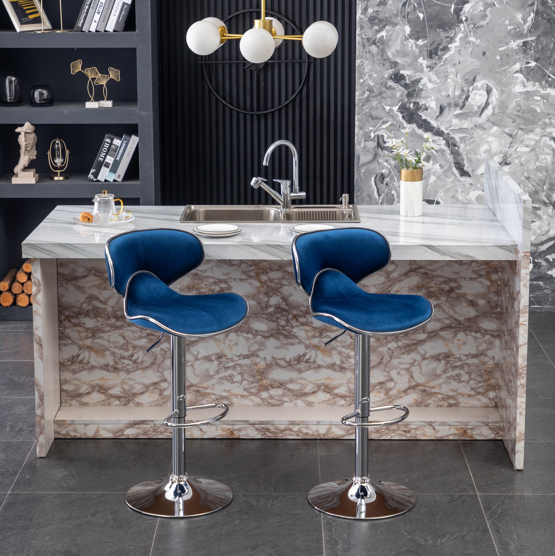 Two plush navy blue velvet bar stools with chrome bases and adjustable height for modern kitchens