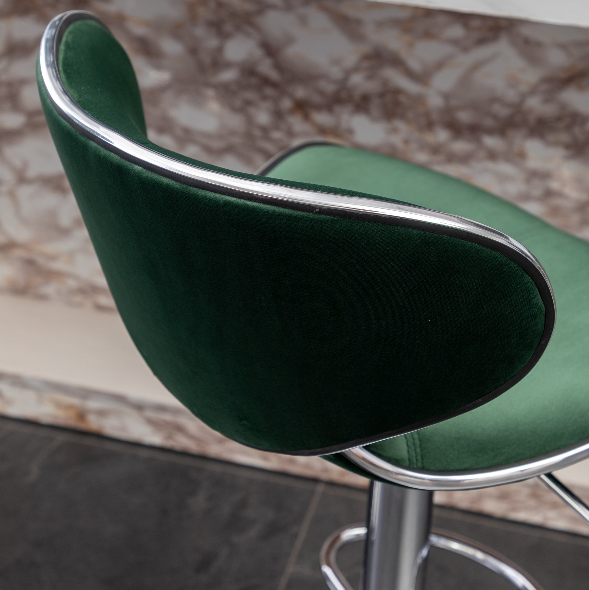Emerald green velvet bar stool with polished chrome trim