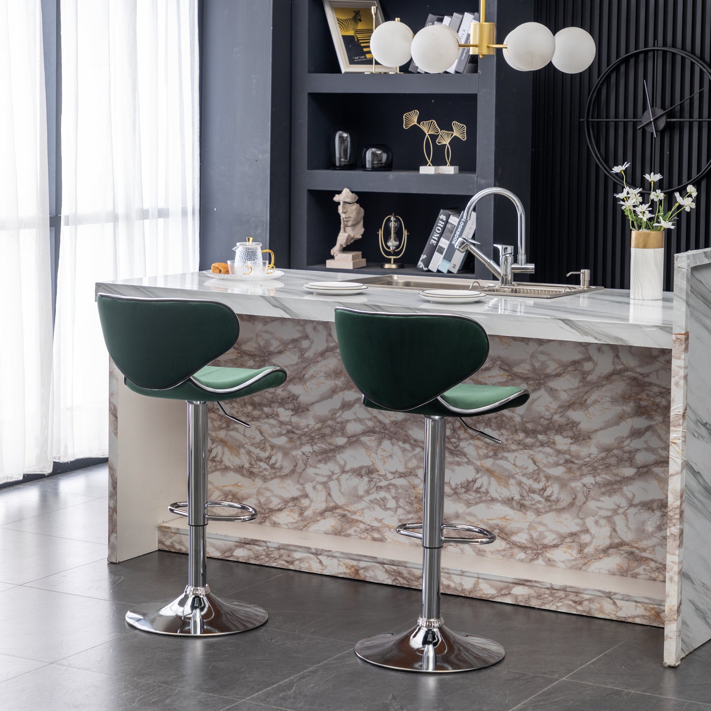 Two modern dark green velvet bar stools with chrome bases in a kitchen setting