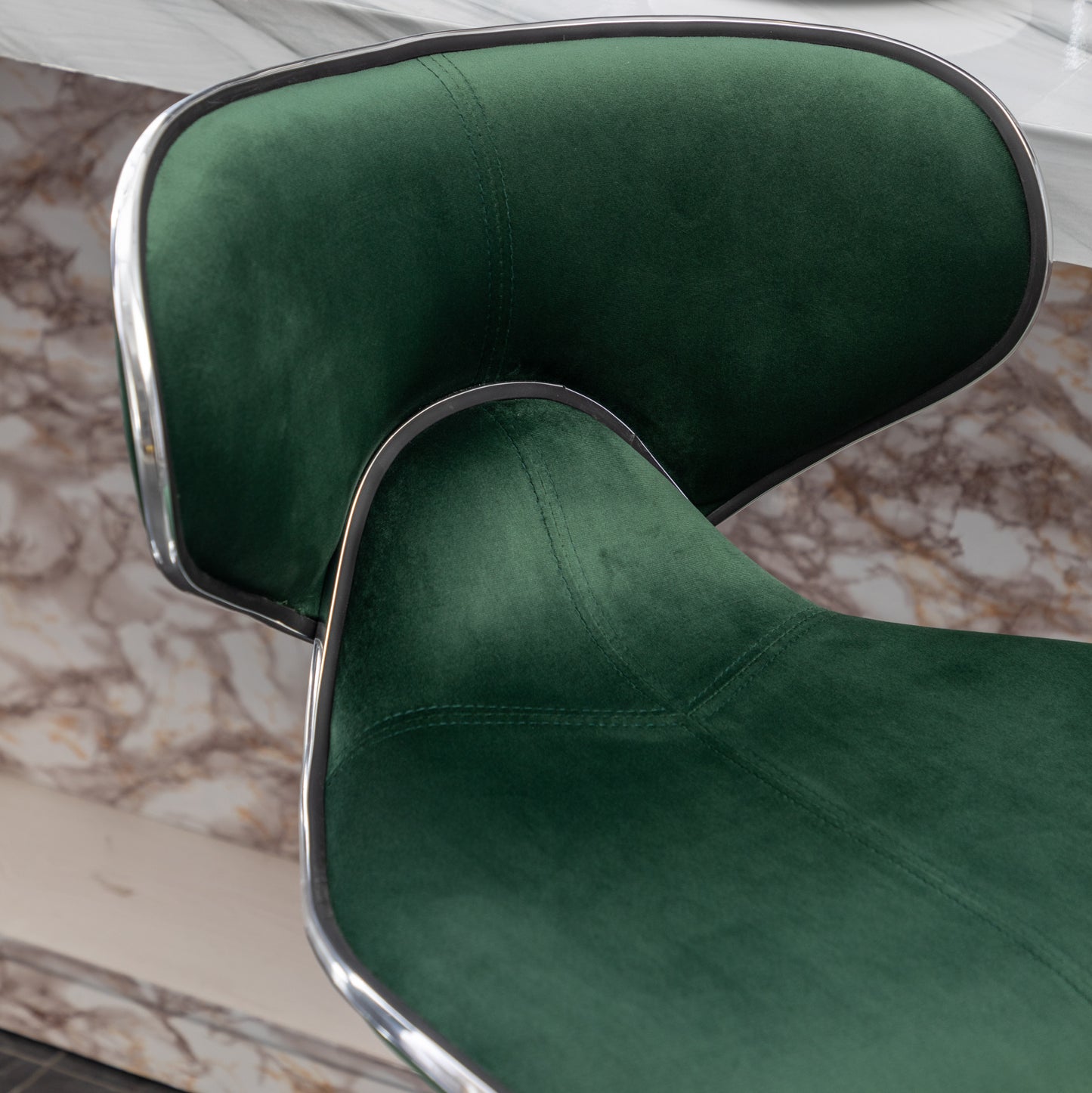 Green velvet bar stool seat with polished chrome trim