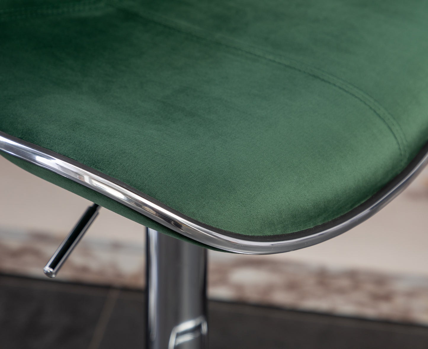 Emerald green velvet seat cushion with chrome trim detail