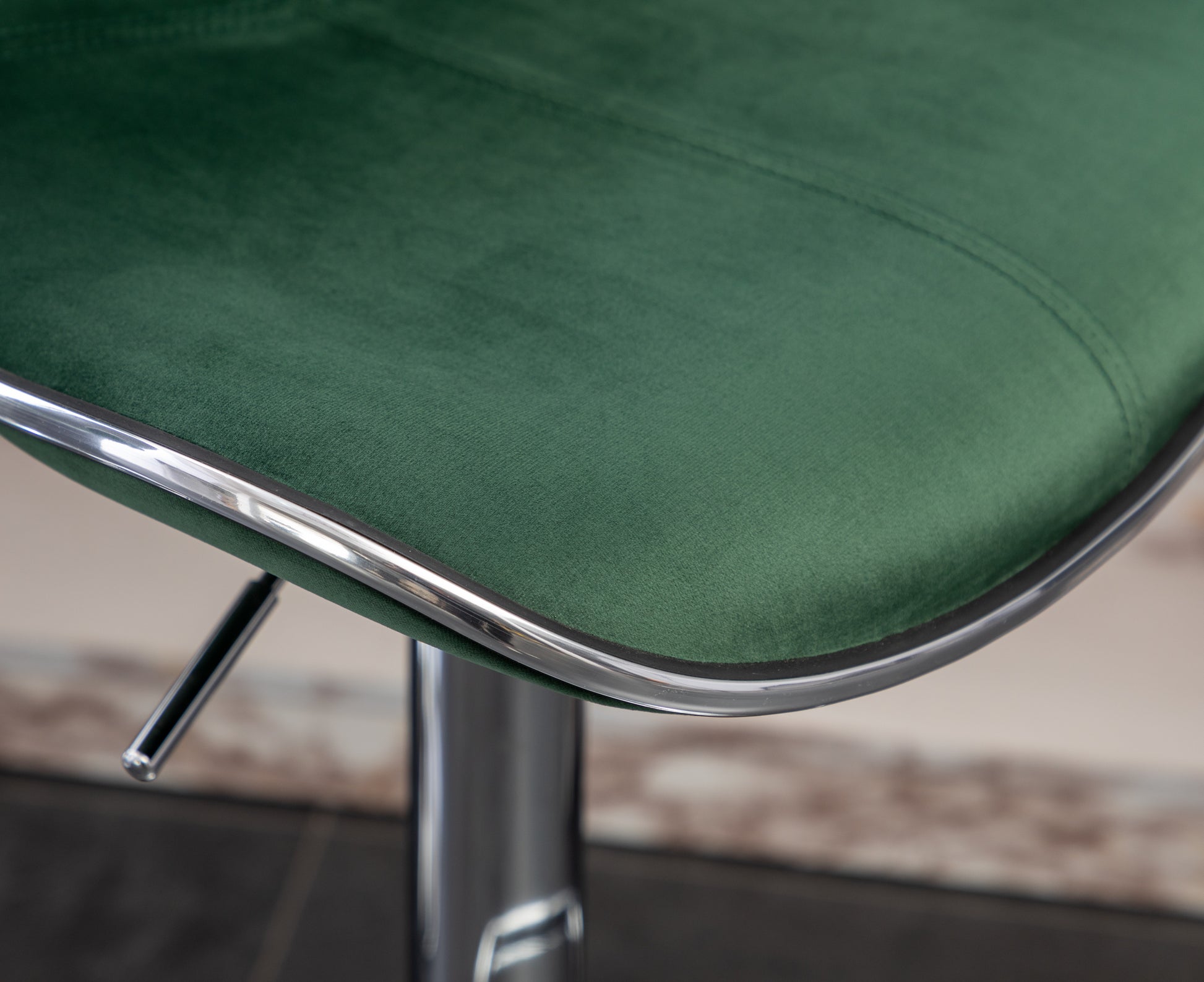 Emerald green velvet seat cushion with chrome trim detail