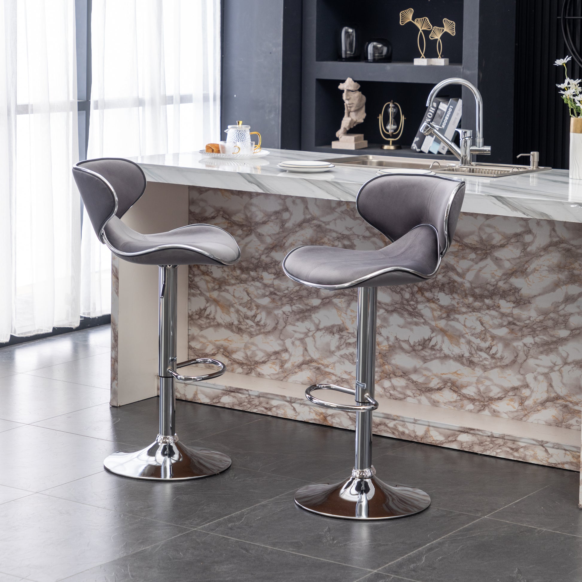 Grey velvet bar stool with chrome accents and adjustable height