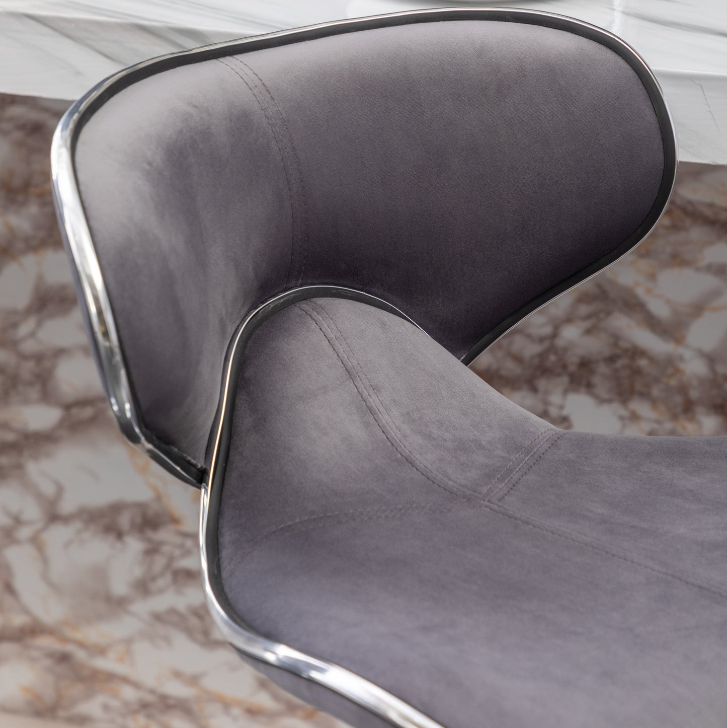 Grey velvet counter stool seat with chrome trim detail