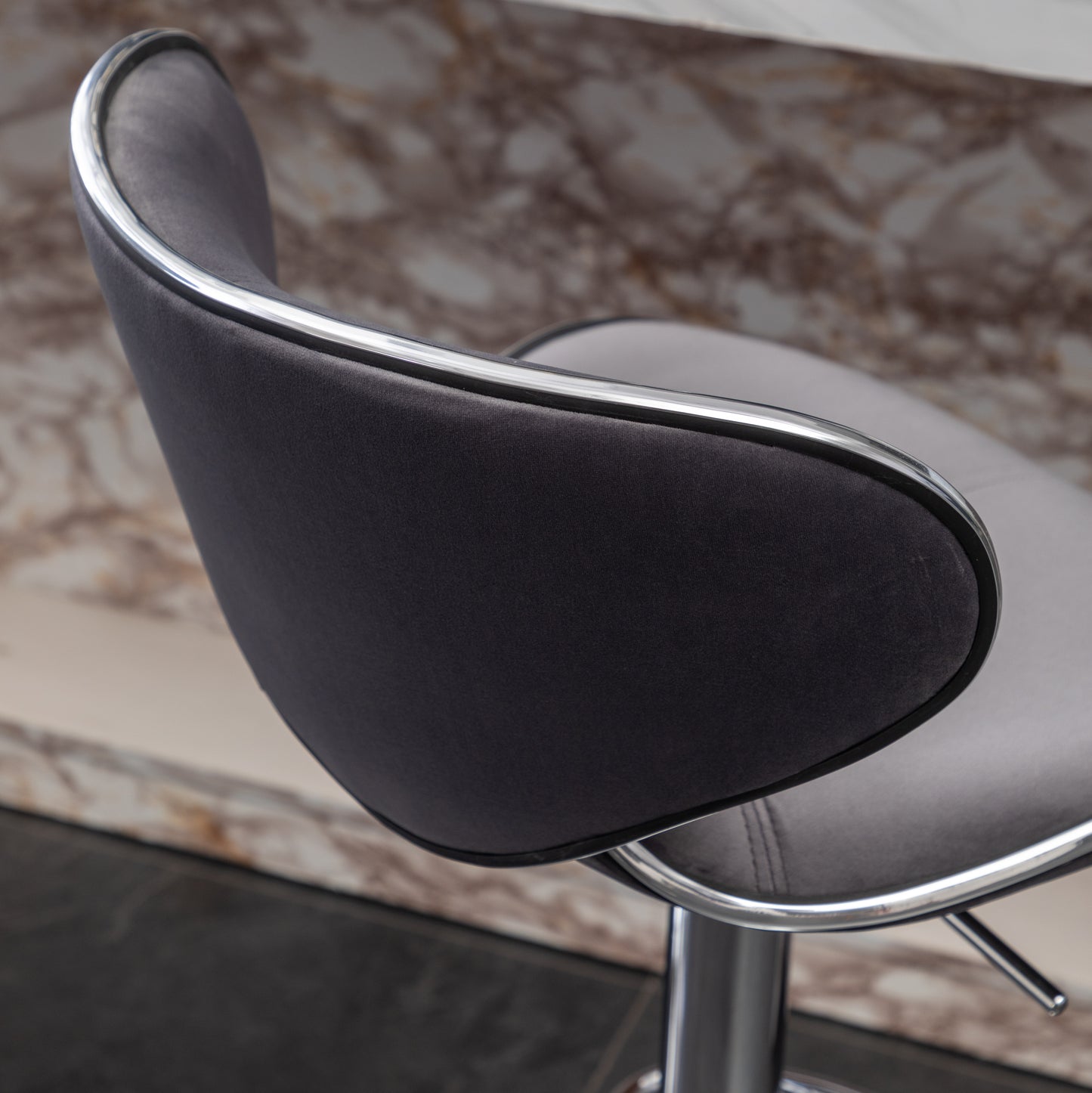 Dark grey upholstered bar stool with chrome trim