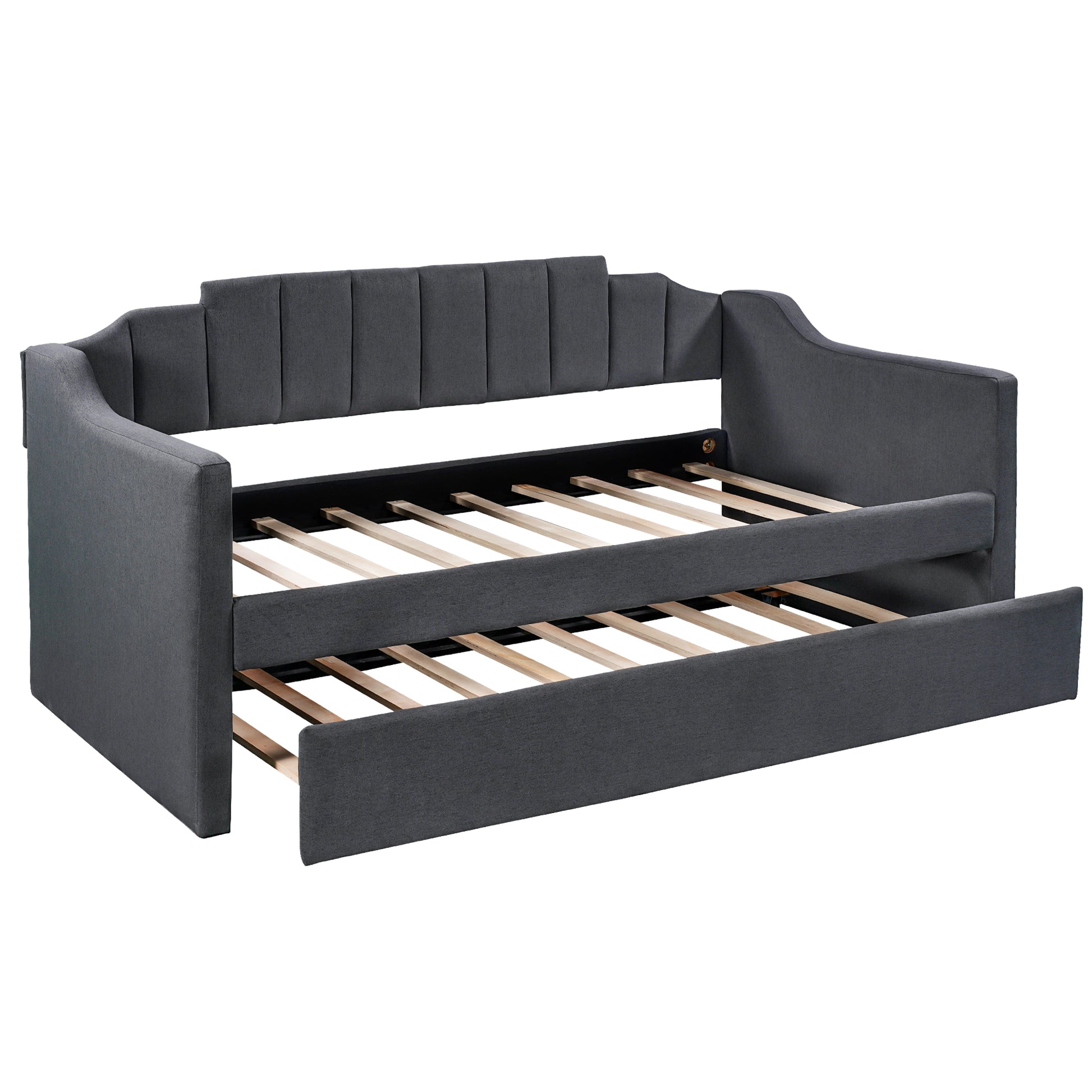 Dark grey upholstered daybed with pullout trundle featuring channel tufted back and sleek arms