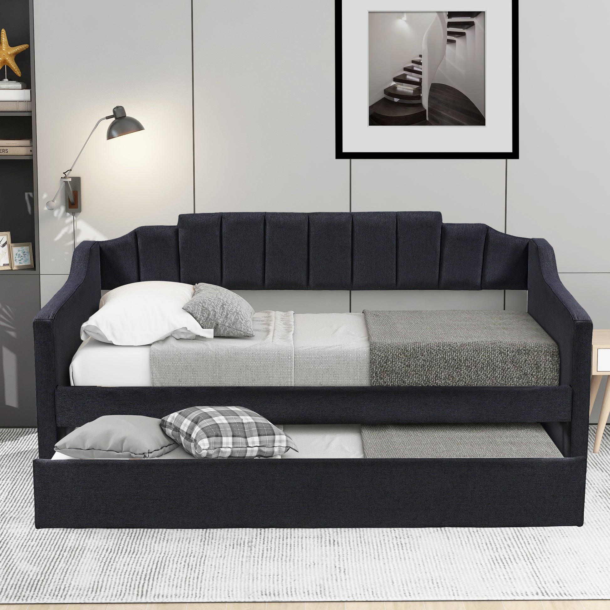 Dark gray upholstered daybed with pullout trundle channel tufted backrest and square arms