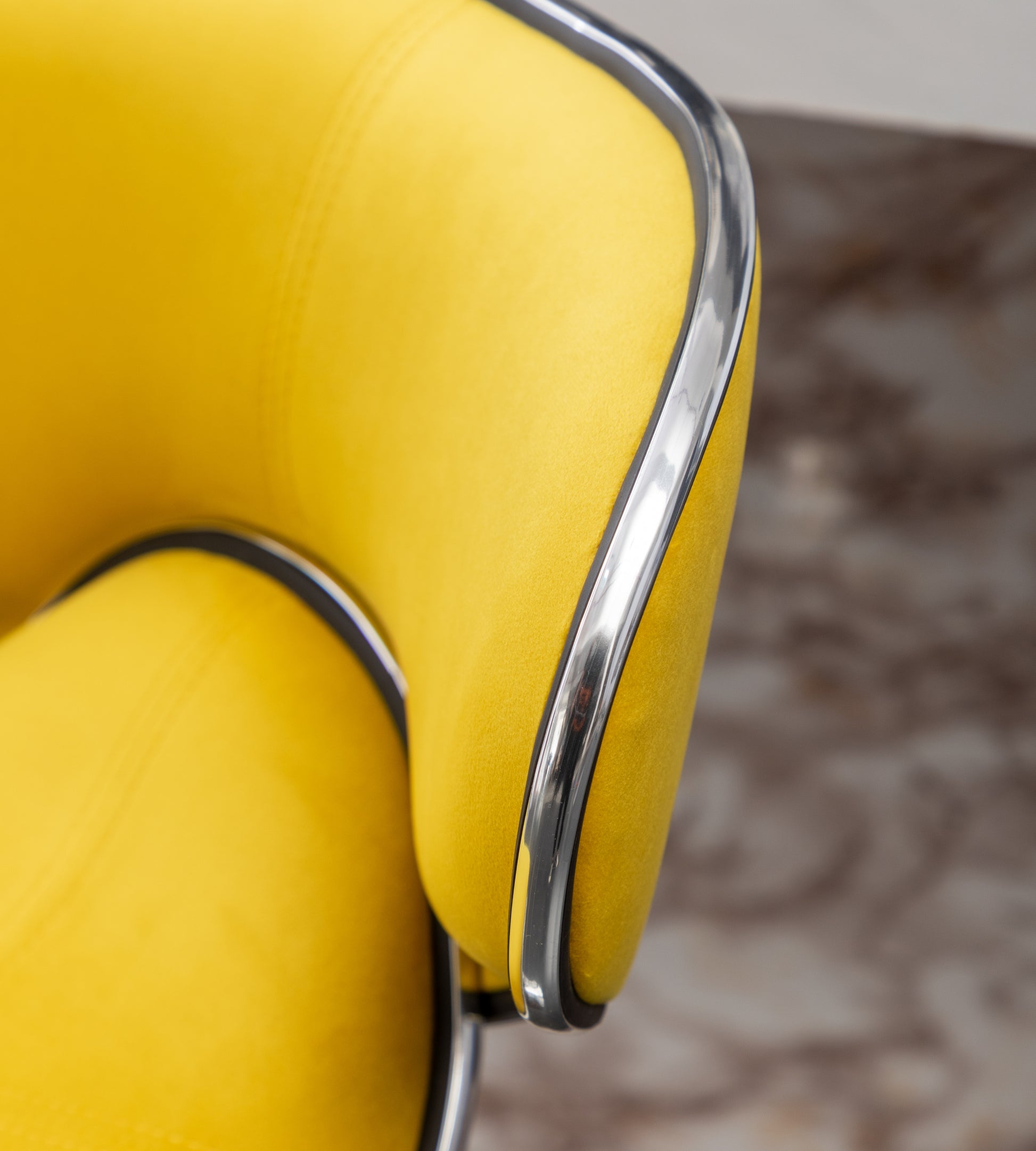 Yellow velvet armchair accent with chrome trim detail