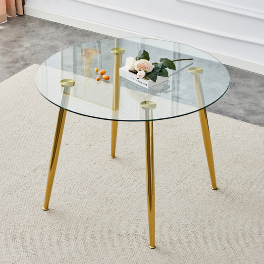 Round glass coffee table with gold tapered legs