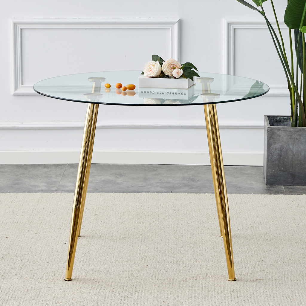 Round glass dining table with gold tapered legs