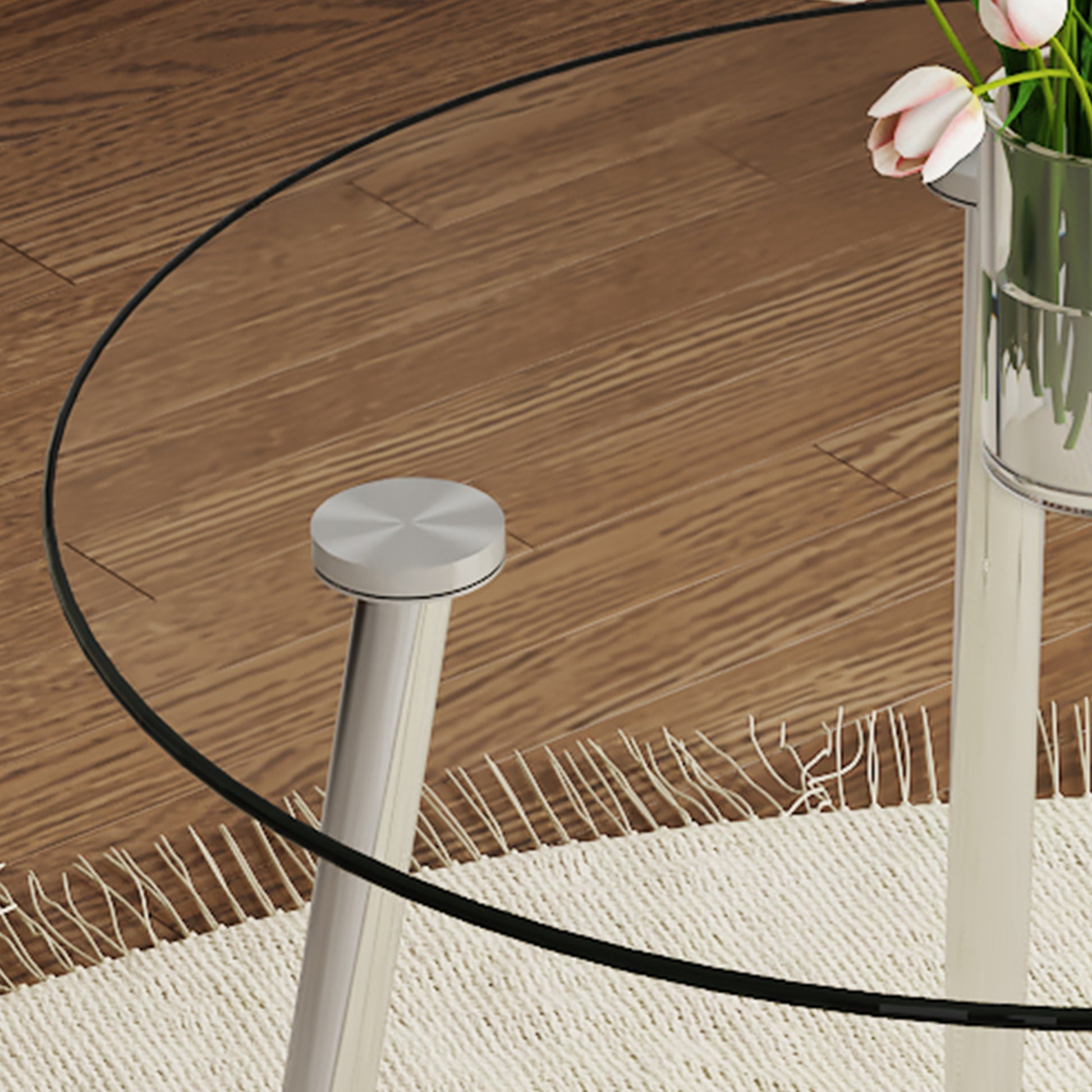 Glass top coffee table with brushed nickel legs on a beige rug