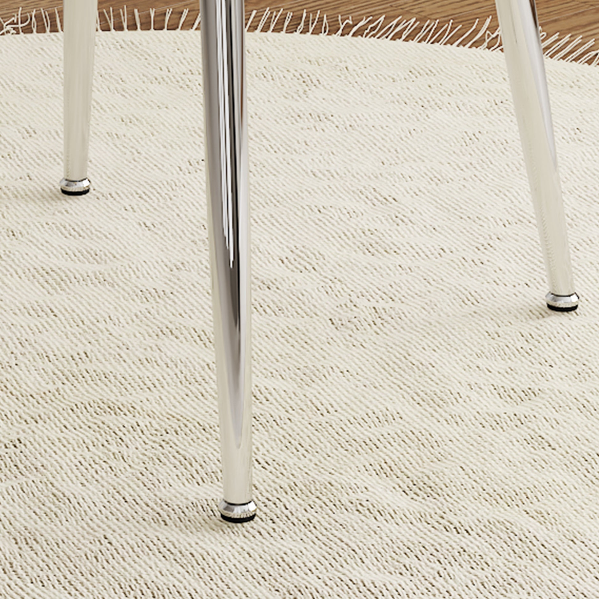 Chrome dining chair legs on a textured cream rug