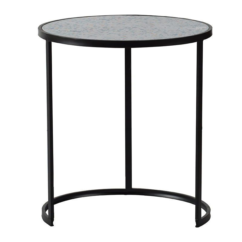 Round terrazzo side table with a black metal frame and legs