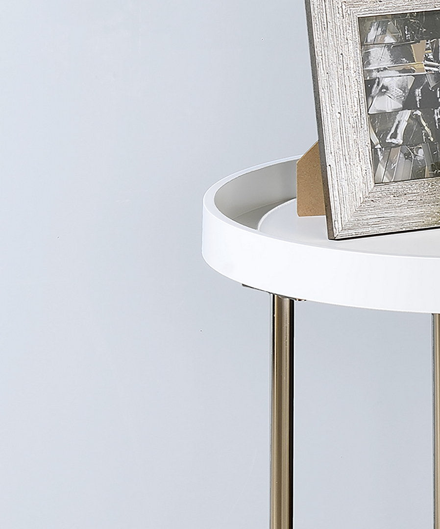 White round accent table with silver metal legs displaying a distressed wooden photo frame