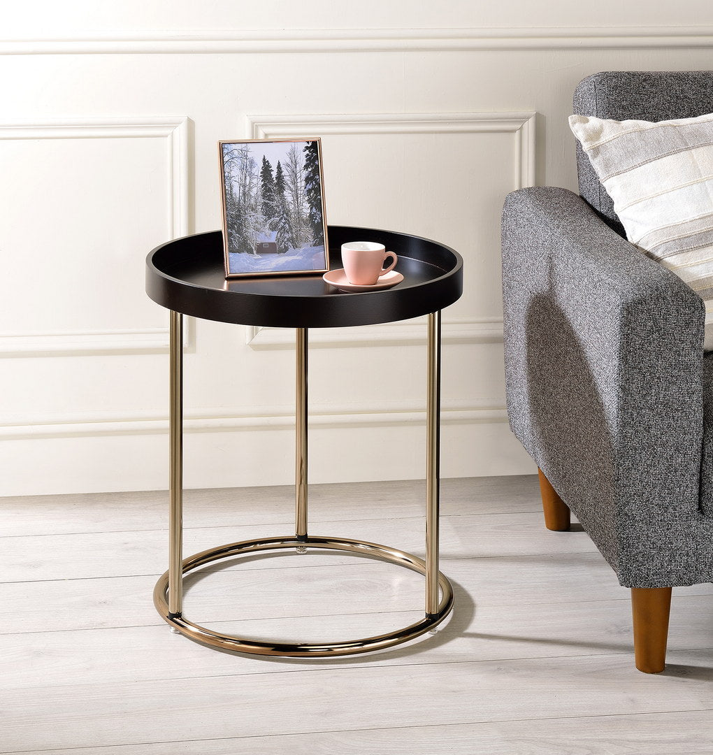 Round black accent table with gold metal base and legs