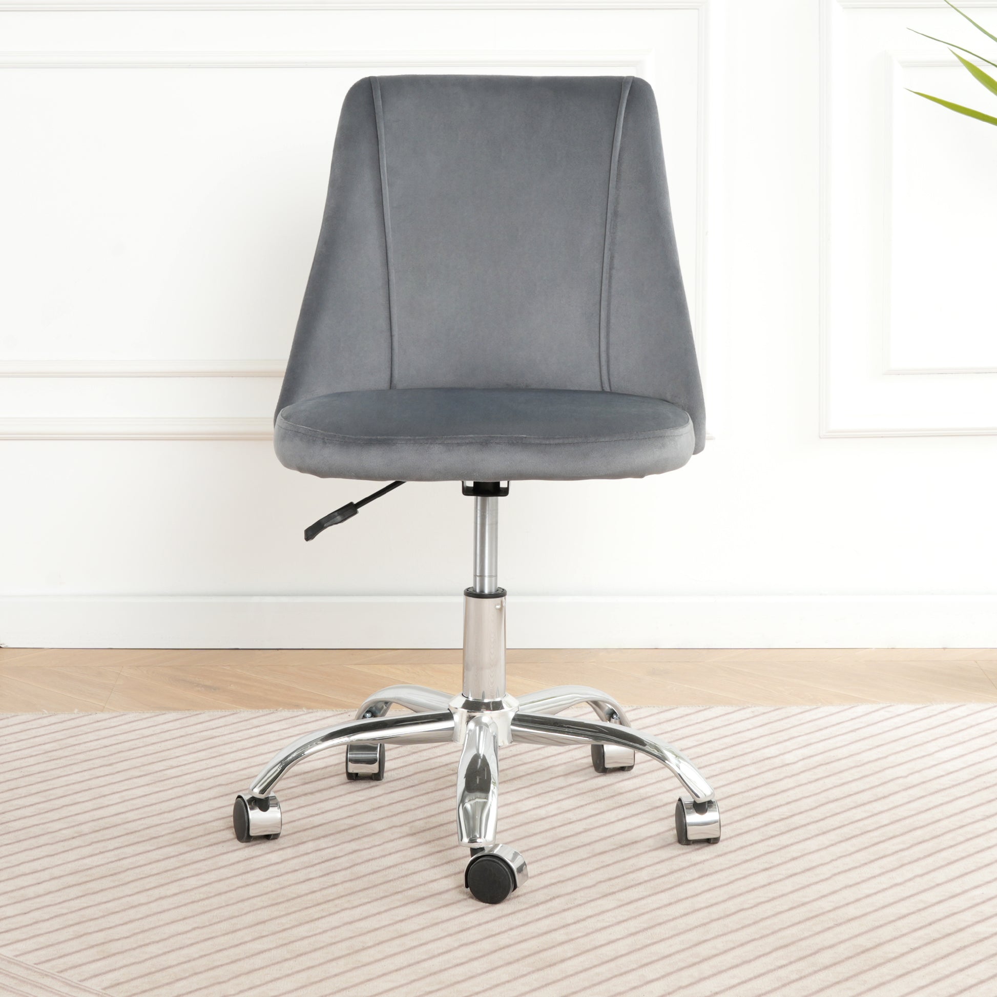Grey velvet office chair with chrome base and wheels