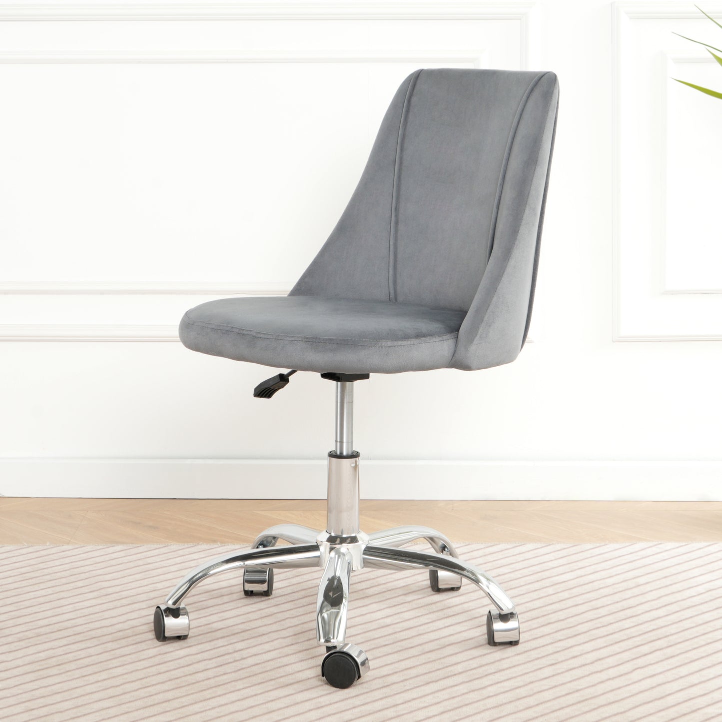 Grey velvet accent chair with adjustable height and casters