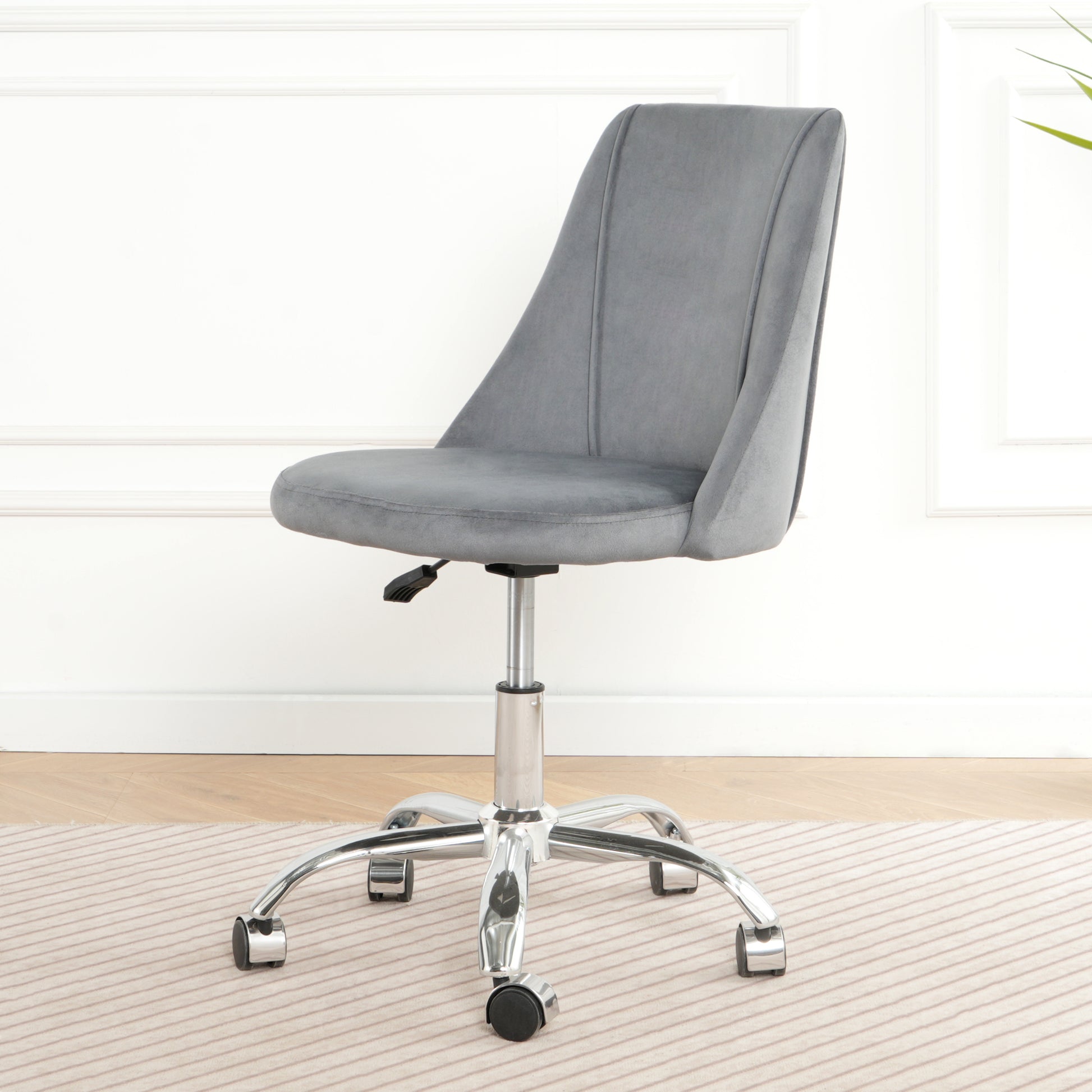 Grey velvet accent chair with adjustable height and casters