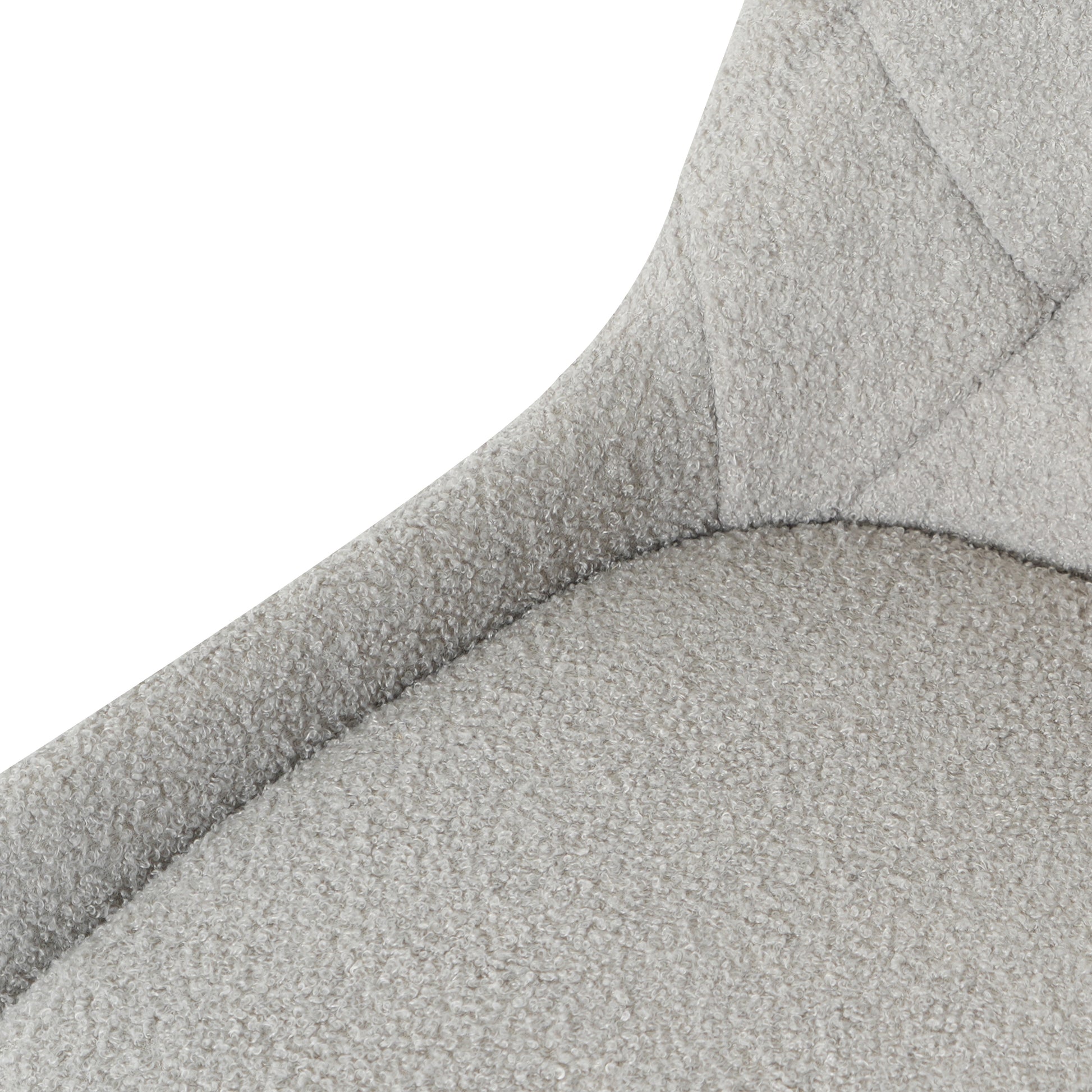 Closeup of light grey boucle fabric on a modern chair