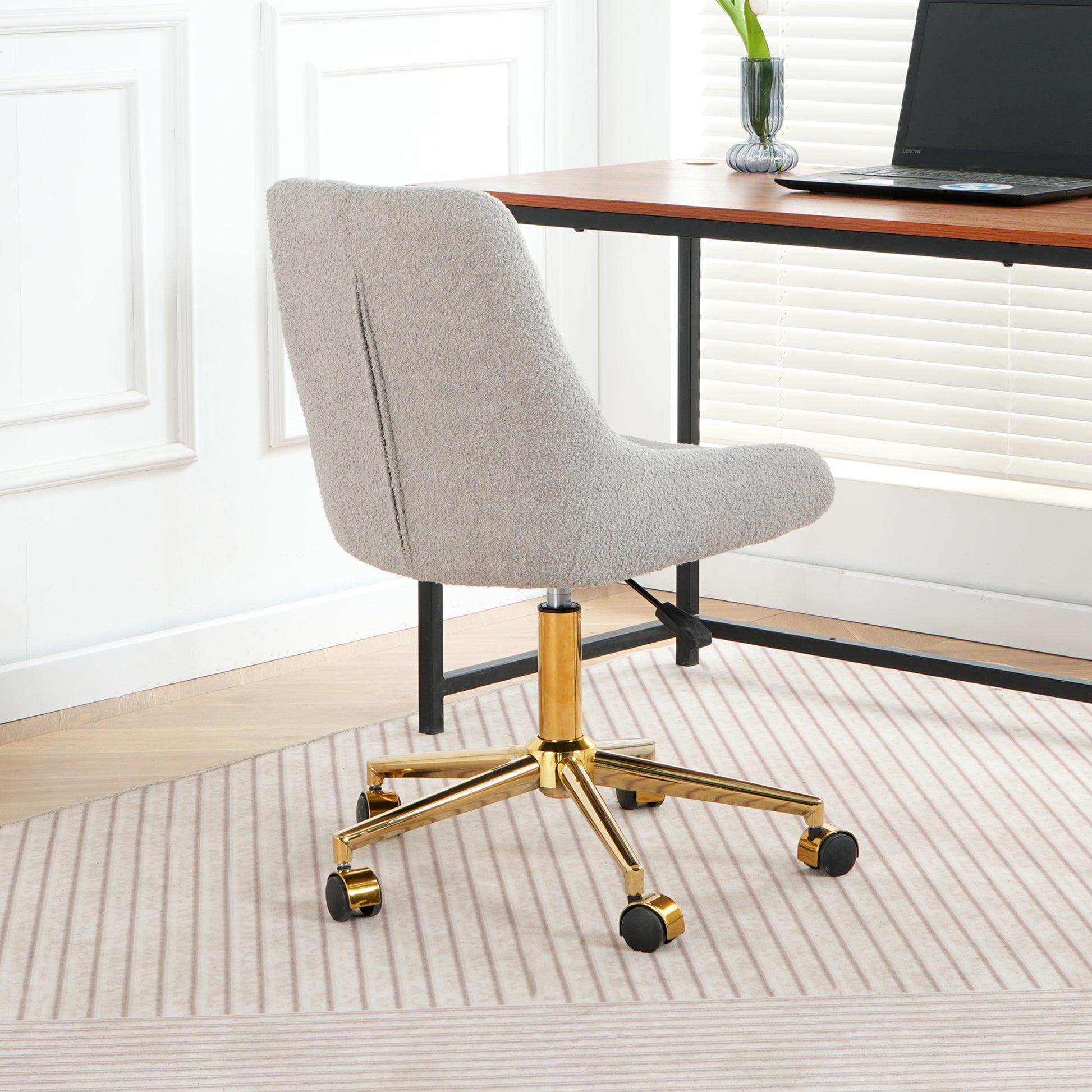 Light gray boucle fabric office chair with gold base and wheels