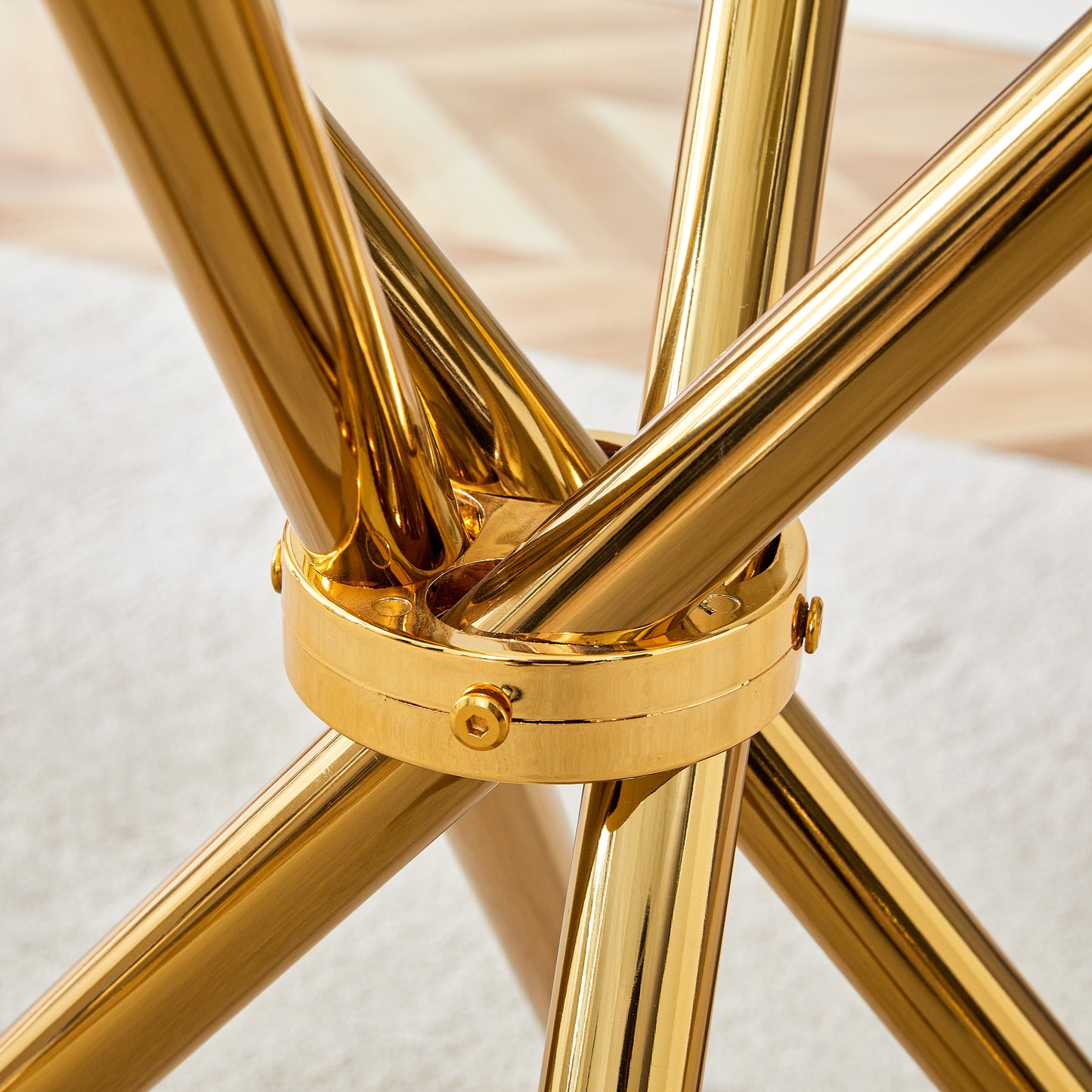 Closeup of polished brass table base with intersecting legs