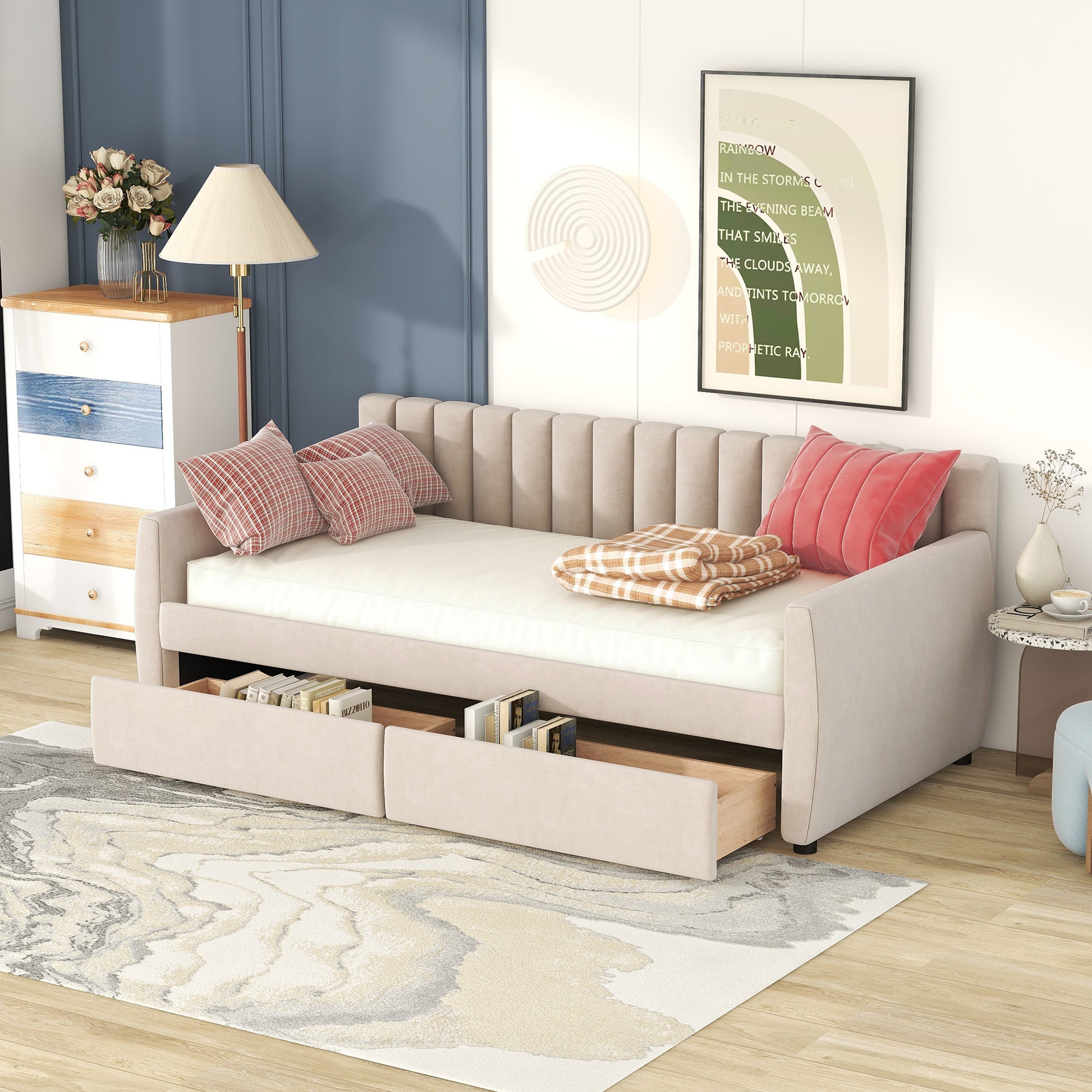 Beige upholstered sofa bed with storage drawers and plaid pillows