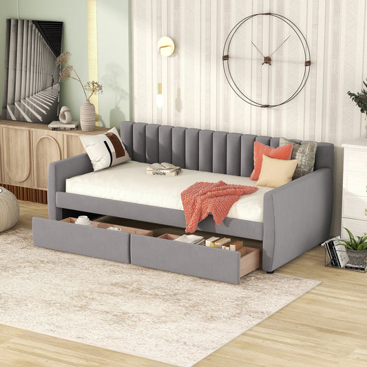 Grey upholstered daybed with two pullout drawers for storage