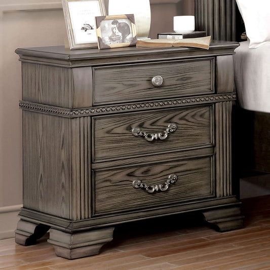 Grey washed wood nightstand with one drawer and two pullout drawers ornate hardware and fluted sides
