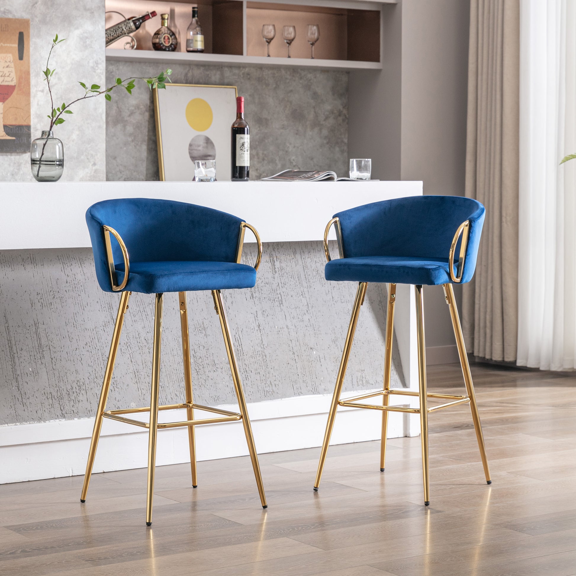 Plush navy velvet bar stool with gleaming gold legs and armrests