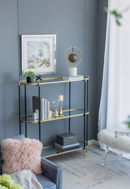 Modern black metal and gold shelving unit with glass shelves and decor