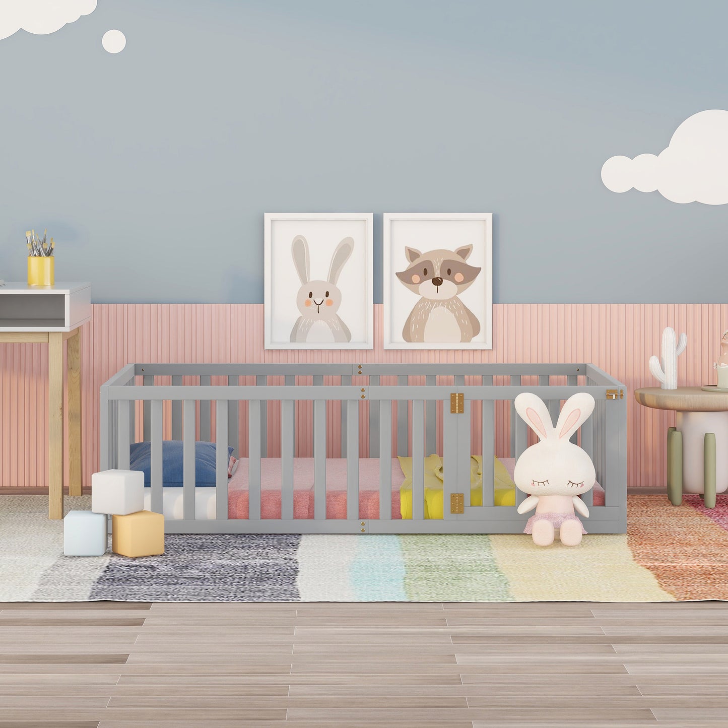 Gray wooden crib with pastel bedding and toys for nursery