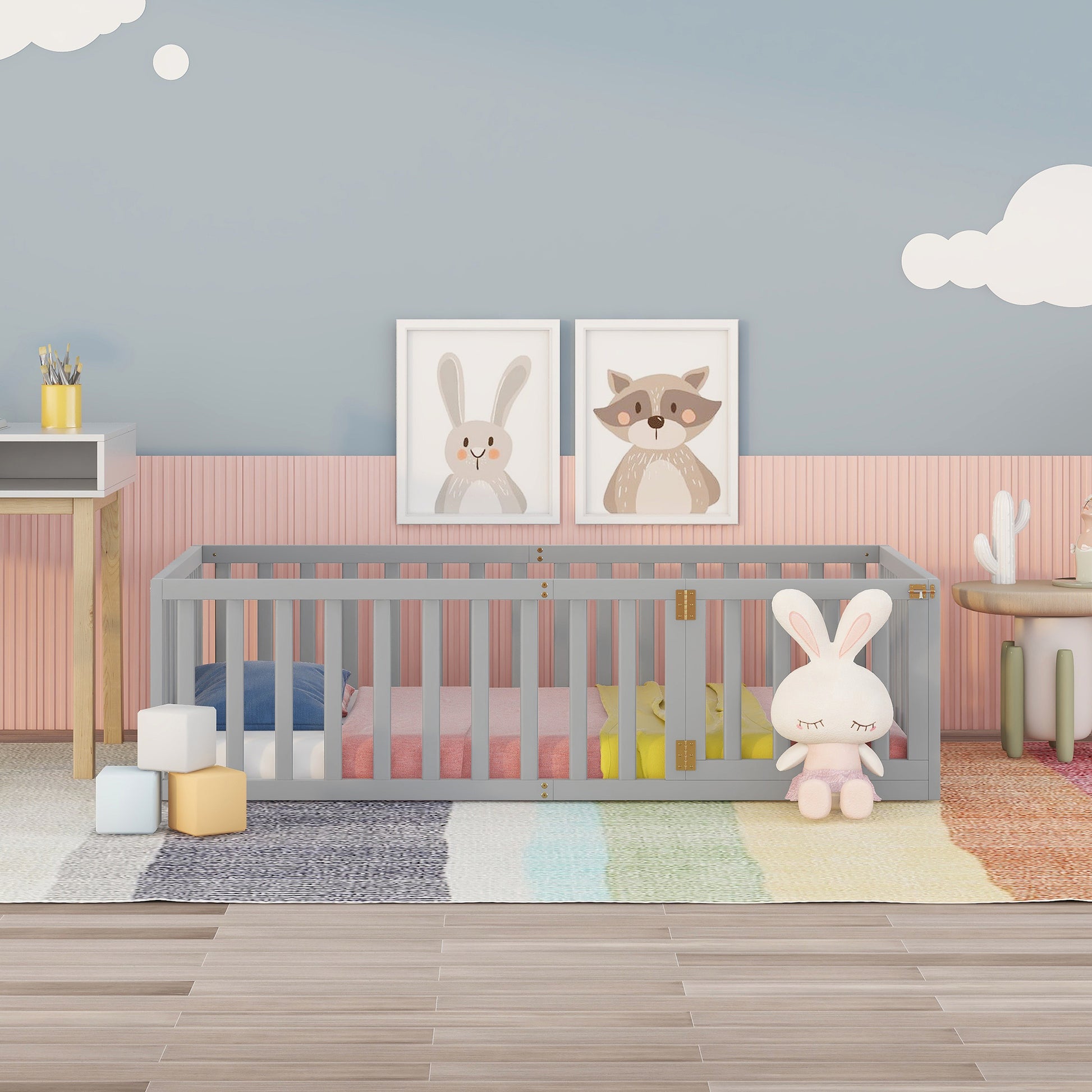 Gray wooden crib with pastel bedding and toys for nursery