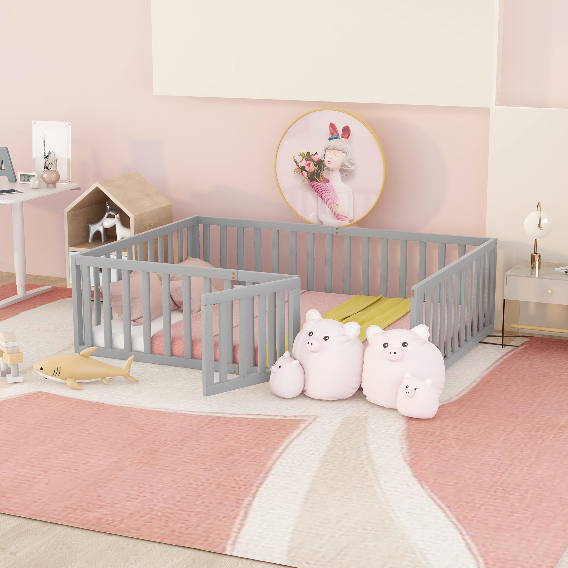 Gray wooden toddler bed with pink bedding and shark toy