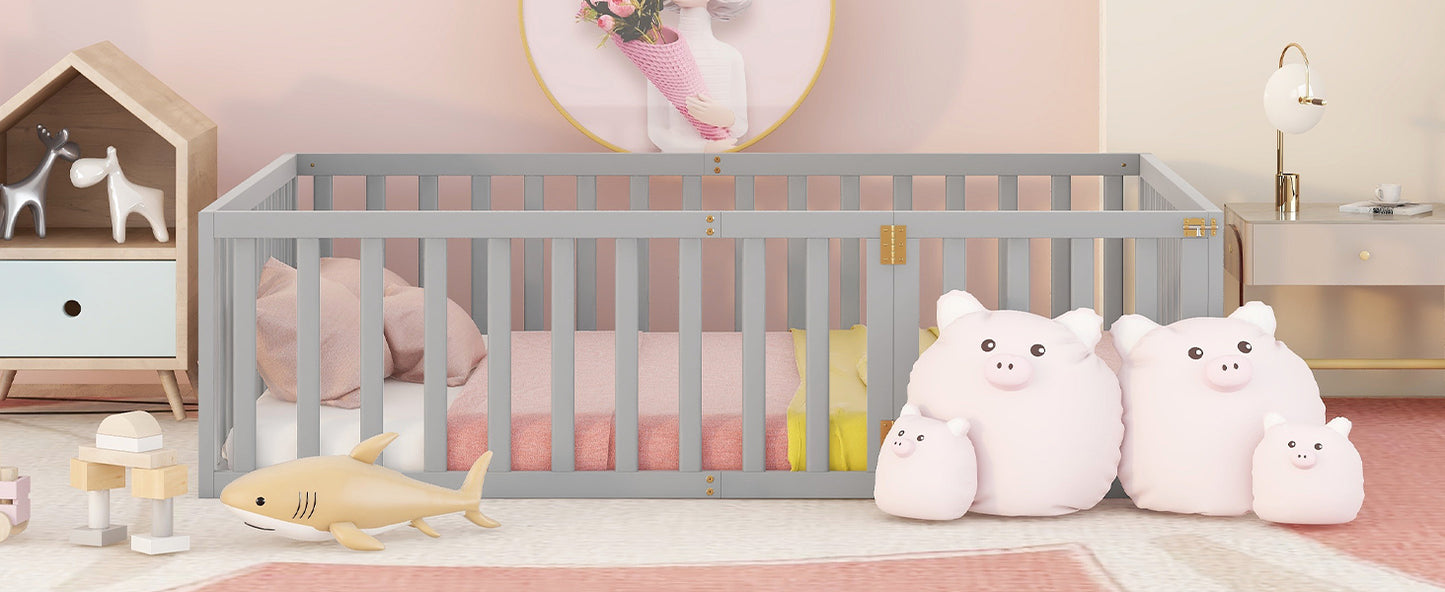 Gray wooden baby crib with pink bedding and shark toy
